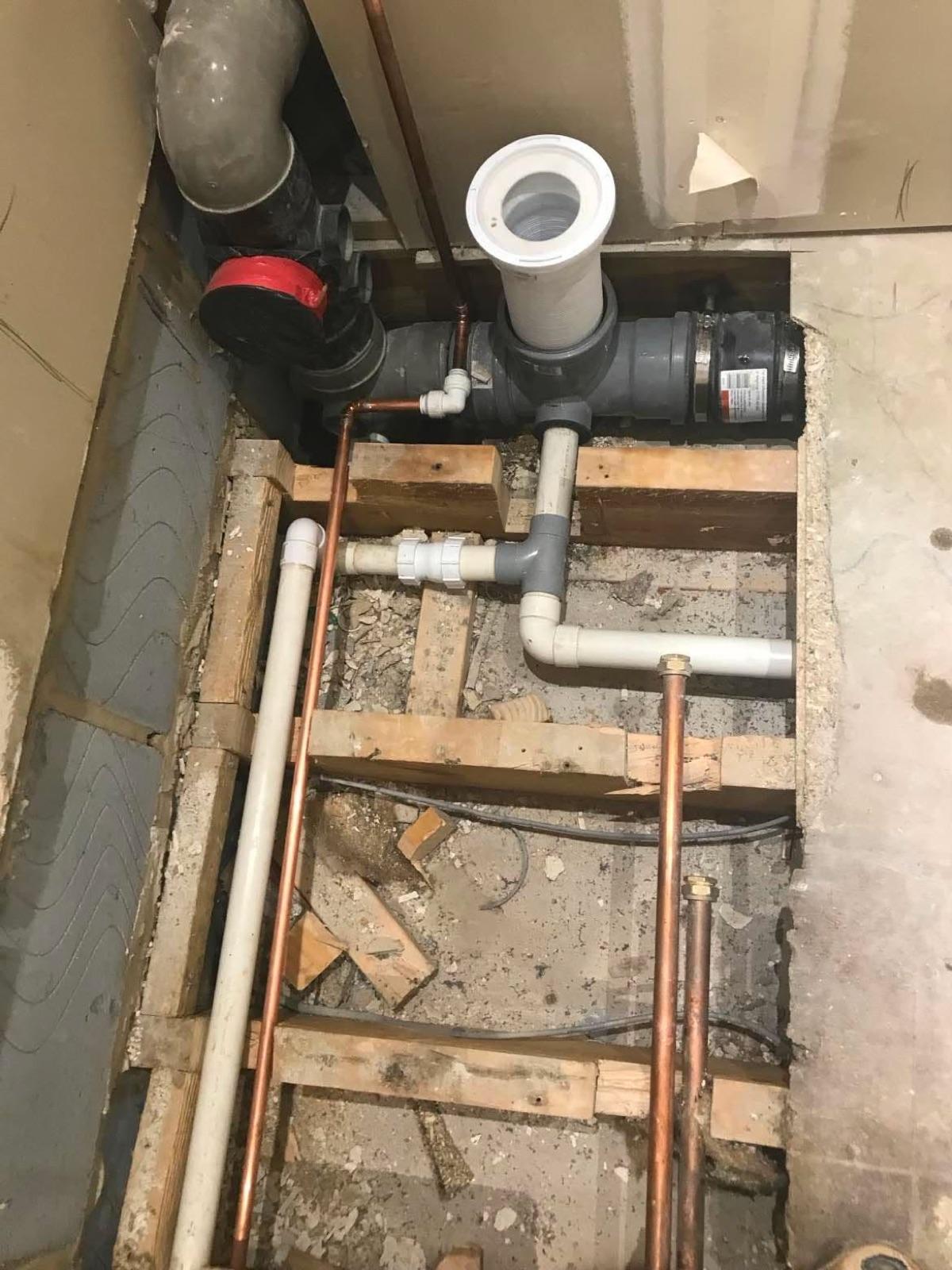 First-fix plumbing in a Nuneaton bathroom — new copper pipework run in before tiling.